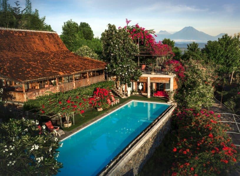 A pool surrounded by tropical gardens